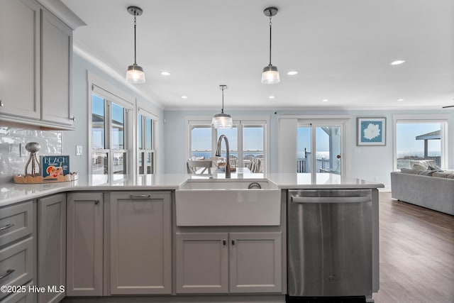 kitchen featuring a healthy amount of sunlight, gray cabinets, dishwasher, and sink