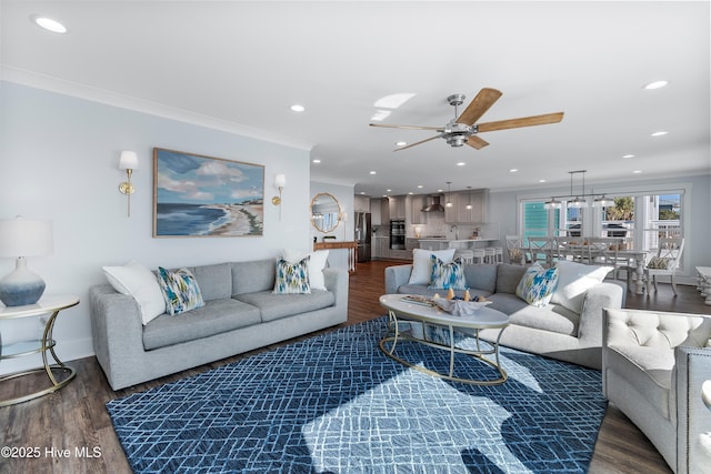 living room with crown molding, dark hardwood / wood-style floors, and ceiling fan