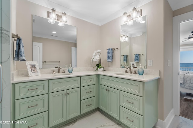 bathroom with ornamental molding, a water view, and vanity