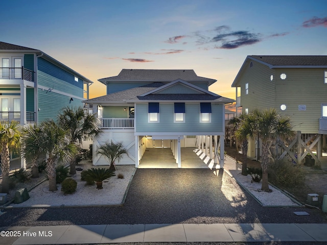 raised beach house featuring a carport