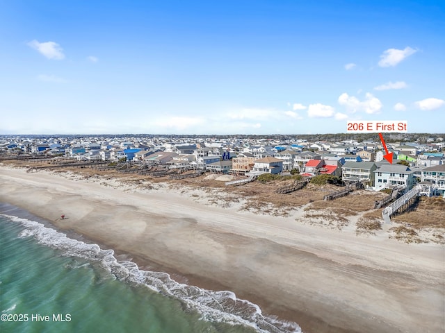 bird's eye view with a water view and a beach view