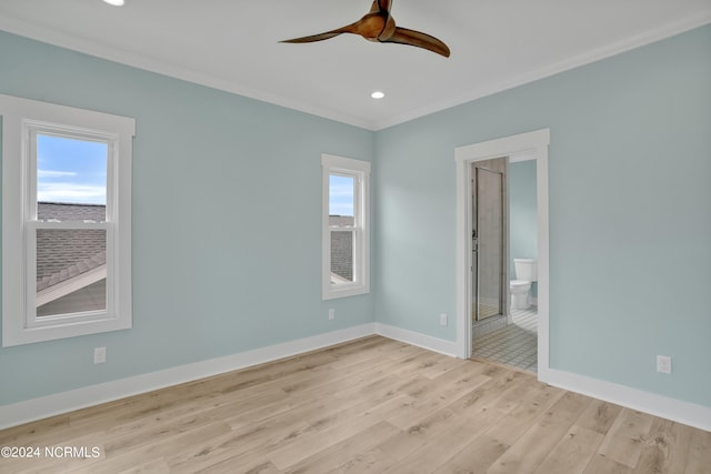 empty room featuring crown molding, light hardwood / wood-style flooring, and ceiling fan