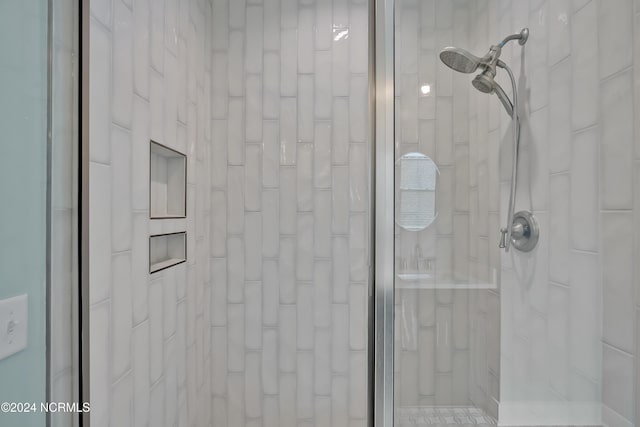 bathroom with tiled shower