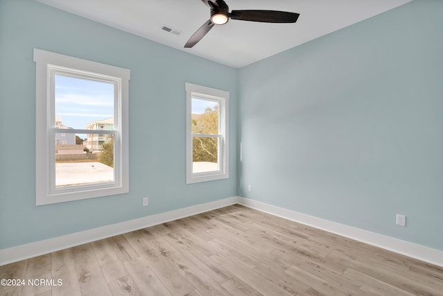 empty room featuring ceiling fan and light wood-type flooring