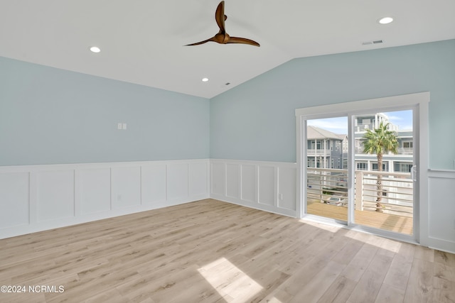 empty room featuring ceiling fan, light hardwood / wood-style flooring, and lofted ceiling