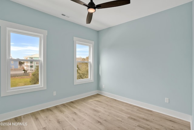 spare room featuring ceiling fan and light hardwood / wood-style flooring