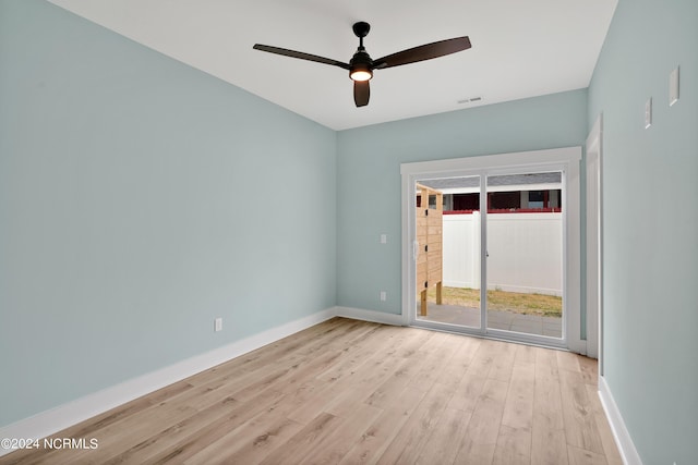 spare room with light wood-type flooring and ceiling fan