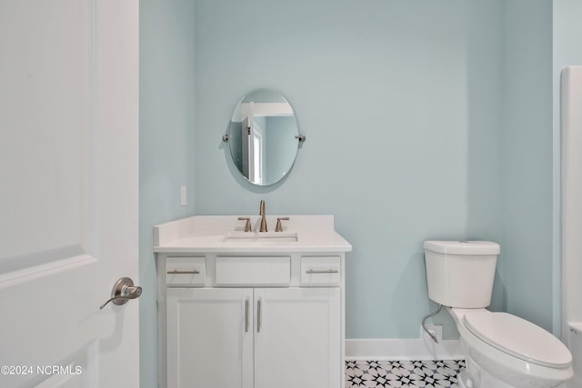 bathroom featuring toilet and vanity