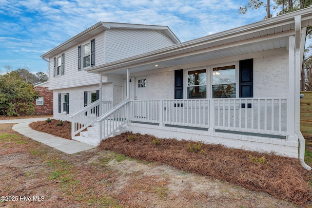 split level home featuring a porch