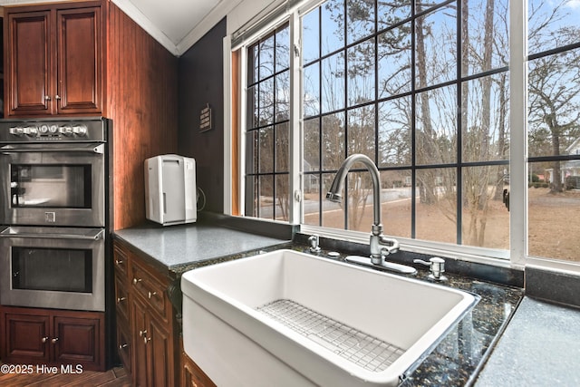 kitchen featuring crown molding, sink, and double oven