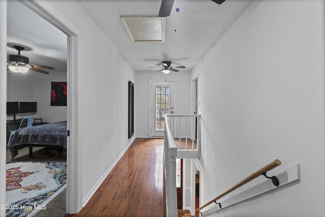 corridor featuring dark hardwood / wood-style floors and a textured ceiling