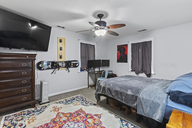 bedroom featuring ceiling fan, carpet floors, and a textured ceiling