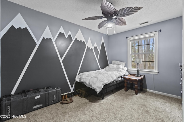 bedroom featuring ceiling fan, carpet, and a textured ceiling