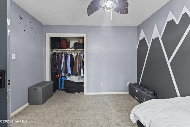 bedroom featuring ceiling fan, carpet floors, a closet, and a textured ceiling