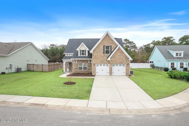 view of front of house with a garage, central AC unit, and a front yard