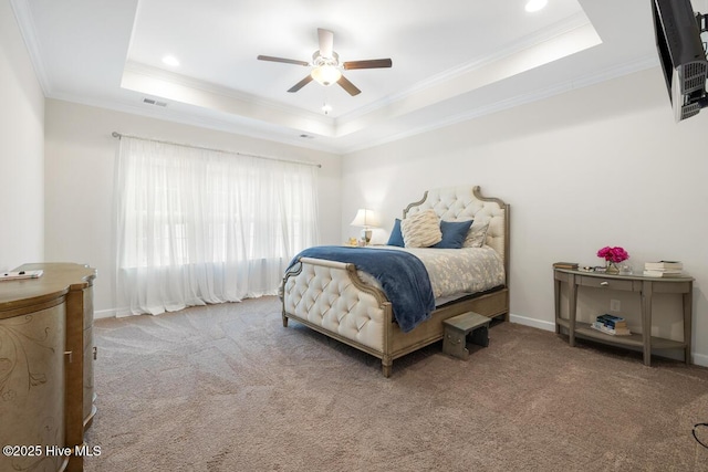 bedroom featuring ornamental molding, carpet, ceiling fan, and a raised ceiling