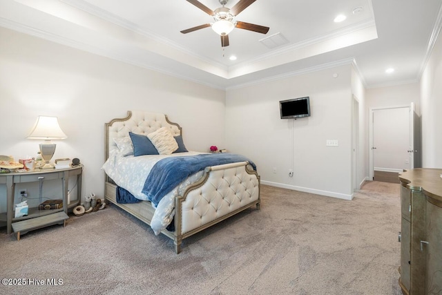 bedroom featuring ceiling fan, a tray ceiling, carpet floors, and ornamental molding