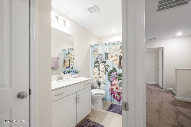 bathroom featuring toilet, vanity, and walk in shower