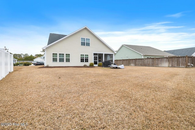 rear view of house featuring a yard