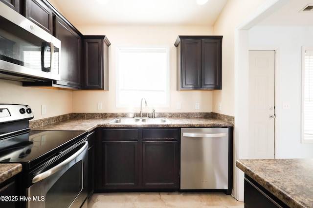 kitchen featuring dark brown cabinetry, appliances with stainless steel finishes, and sink