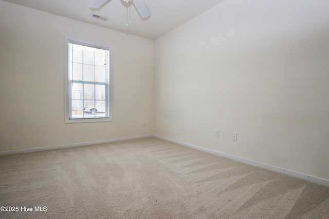 carpeted spare room featuring ceiling fan