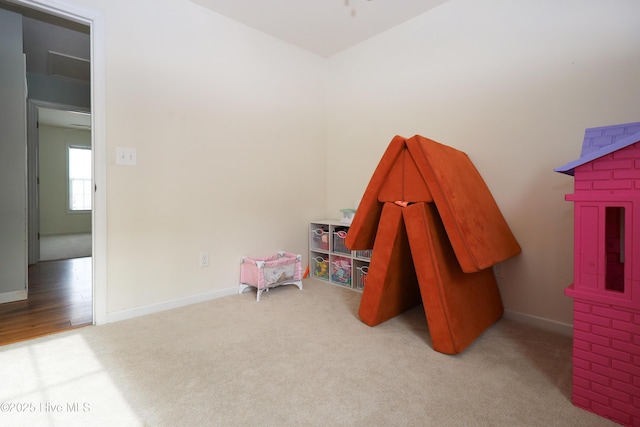 recreation room featuring light colored carpet