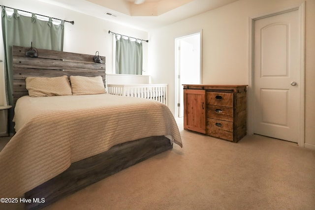 bedroom featuring light carpet