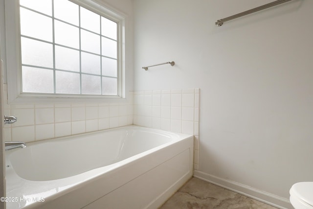 bathroom with a bathing tub and toilet