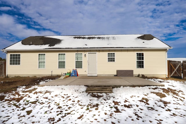 snow covered property featuring a patio