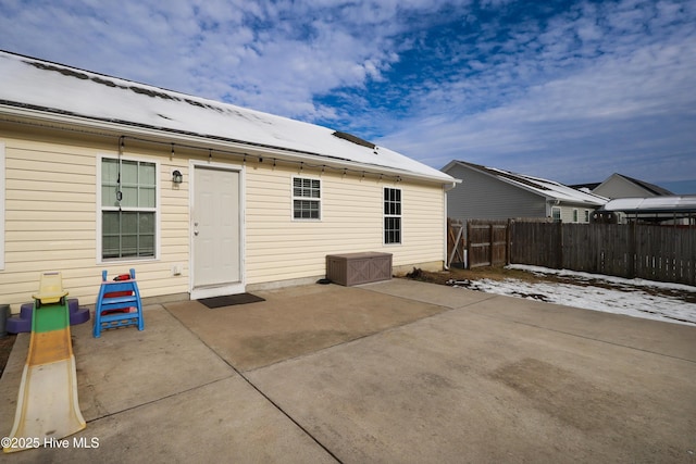 rear view of house featuring a patio area and fence