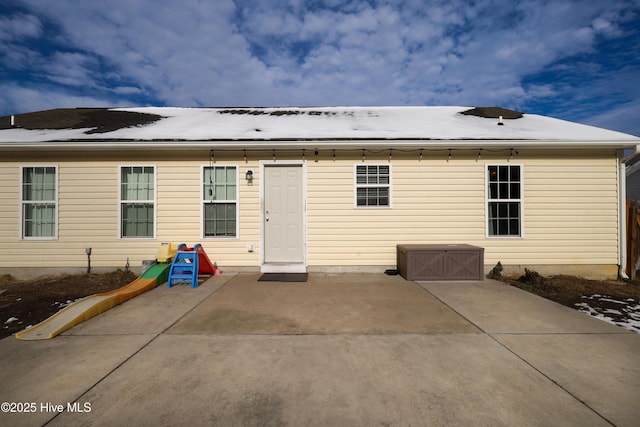 back of property with a patio