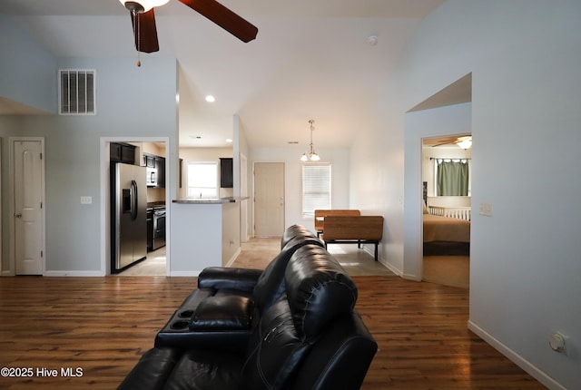 living room featuring lofted ceiling, hardwood / wood-style flooring, and ceiling fan