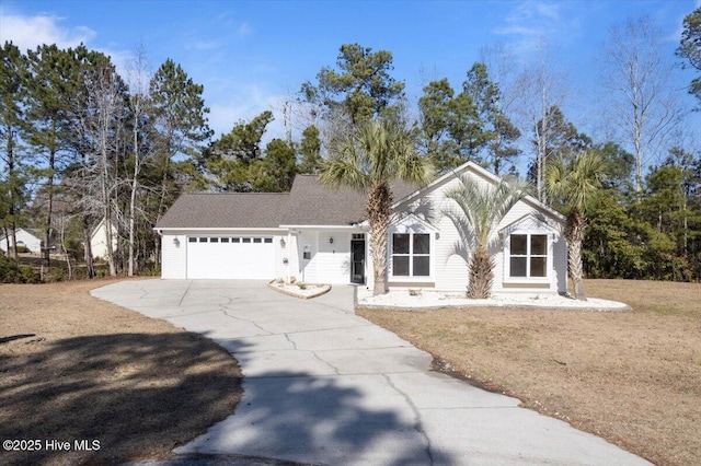 view of front of property featuring a garage and a front yard