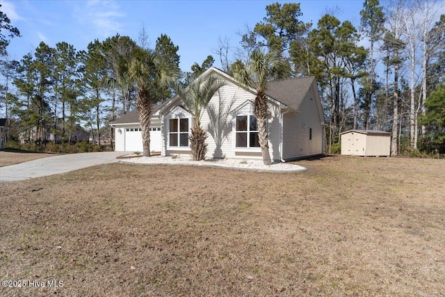 view of front facade with a garage, a storage shed, and a front lawn