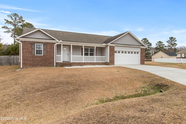 ranch-style home with a garage, a front yard, and covered porch