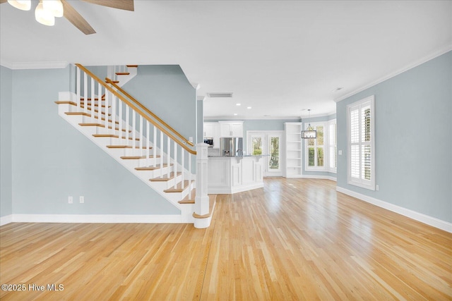 foyer entrance featuring ornamental molding and light hardwood / wood-style floors