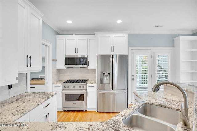 kitchen featuring sink, white cabinetry, and stainless steel appliances