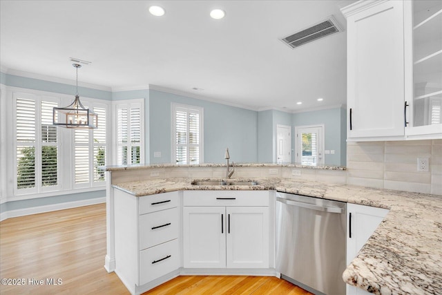 kitchen with sink, stainless steel dishwasher, white cabinetry, and light hardwood / wood-style floors