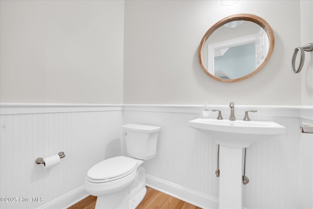 bathroom featuring toilet and hardwood / wood-style flooring