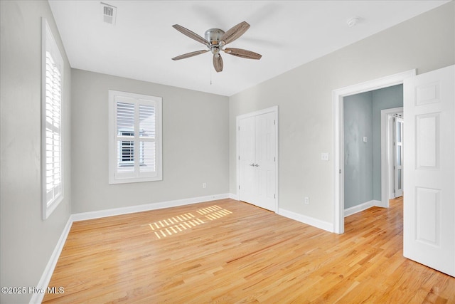 empty room featuring light wood-type flooring and ceiling fan