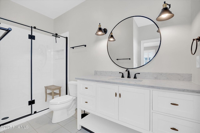 bathroom featuring a shower with shower door, tile patterned floors, vanity, and toilet