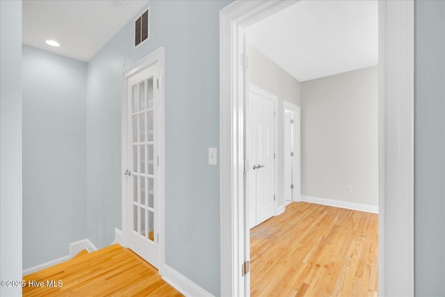 hallway with wood-type flooring