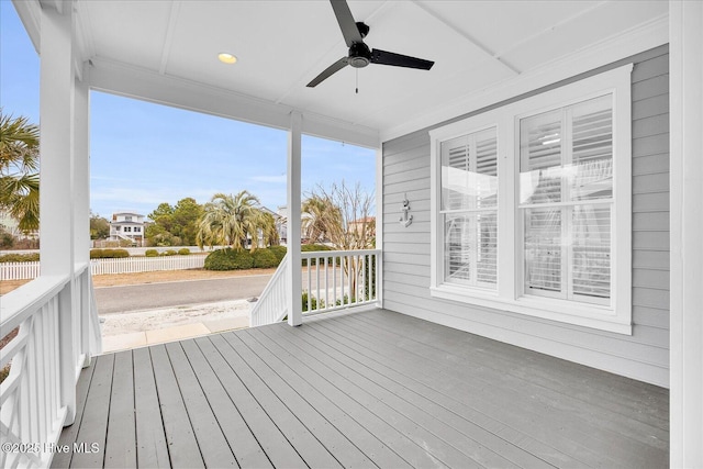 unfurnished sunroom with ceiling fan