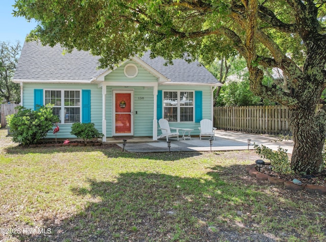 view of front of house featuring a front yard and a patio