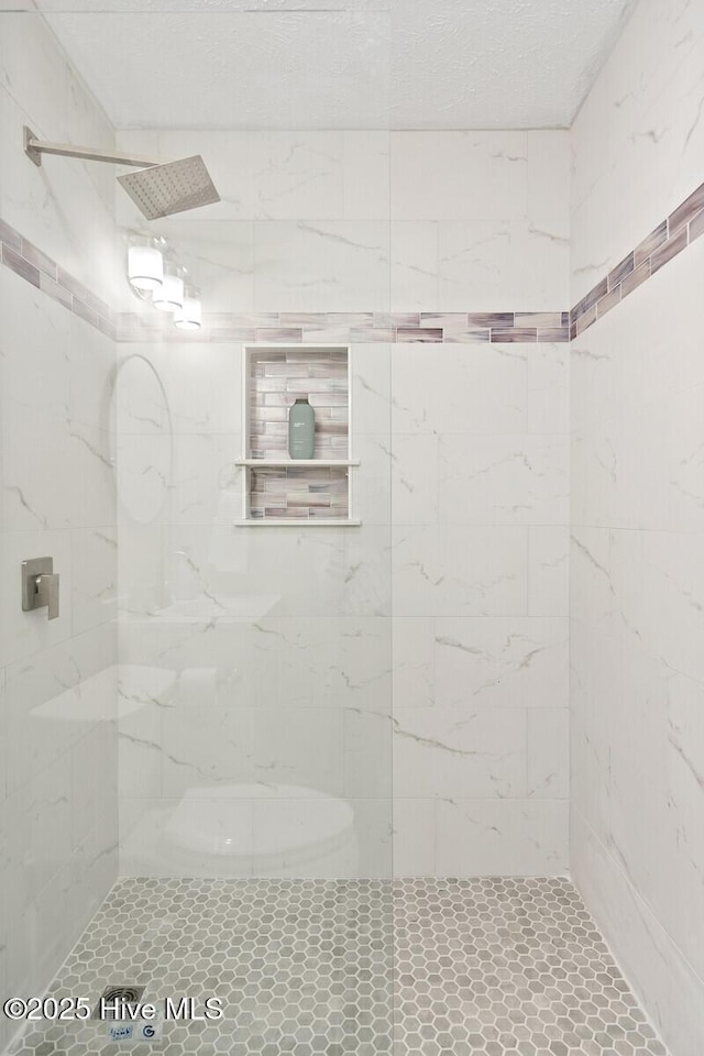 bathroom with tiled shower