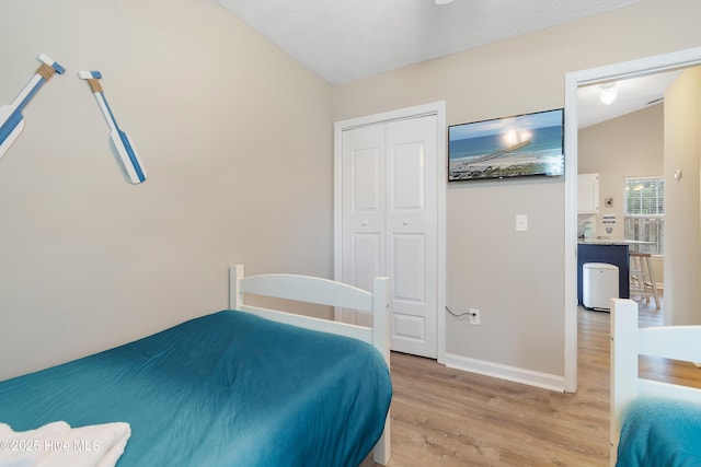 bedroom featuring light wood-type flooring and a closet