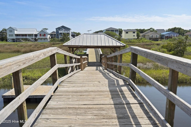 view of dock with a gazebo and a water view