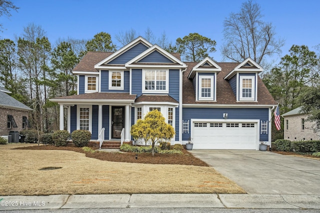 view of front of house with a garage and central AC