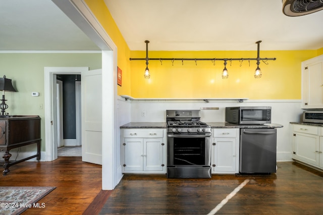 kitchen with pendant lighting, dark hardwood / wood-style flooring, stainless steel appliances, and white cabinets