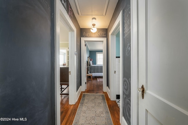 corridor with dark hardwood / wood-style flooring